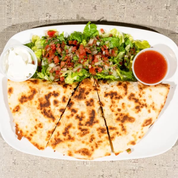 Three quesadilla slices with a side of lettuce, pico de gallo, sour cream, and salsa.